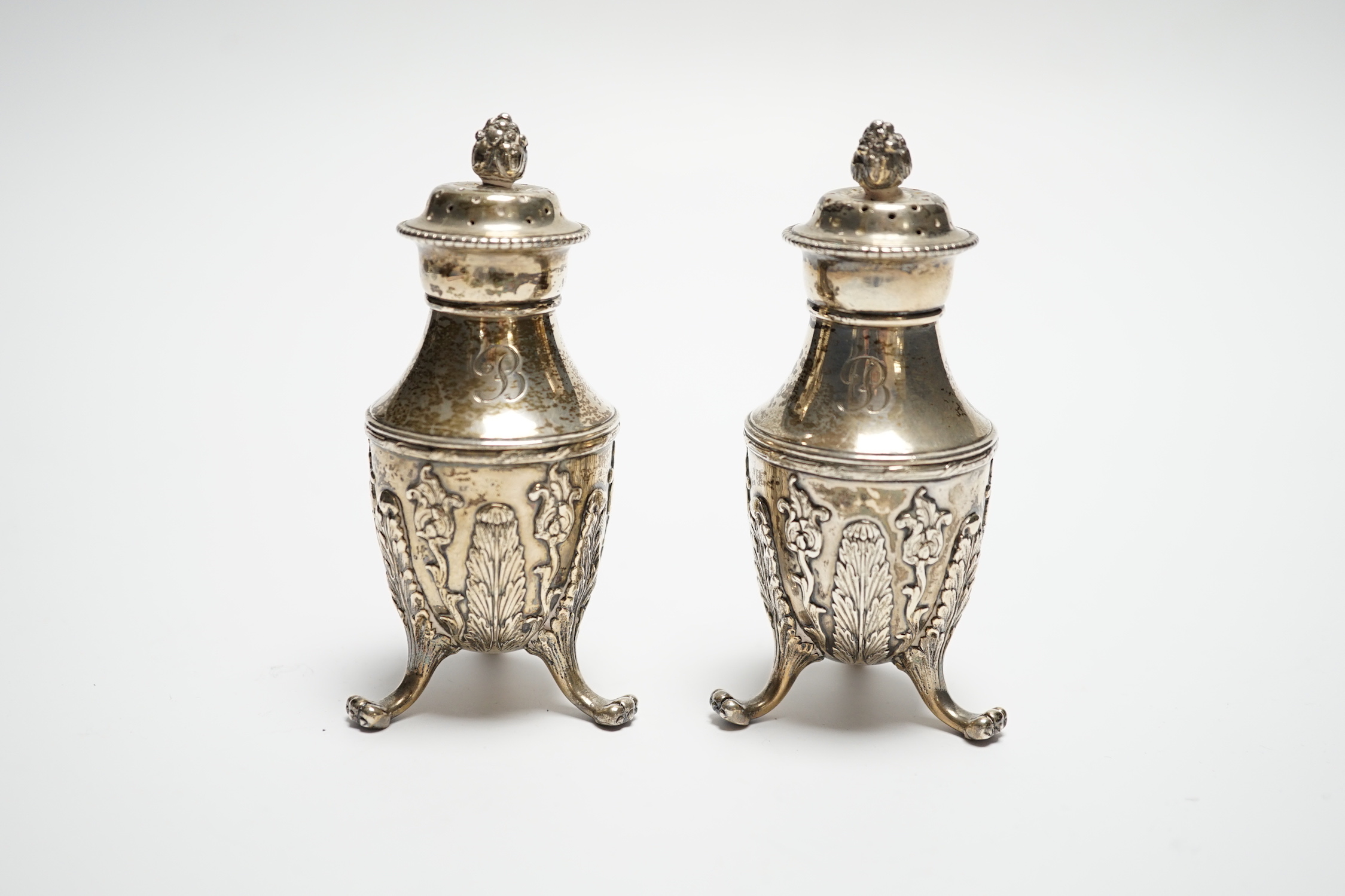 A pair of late 19th century Tiffany & Co sterling pepperettes, on tripod supports, 9cm, 157 grams.